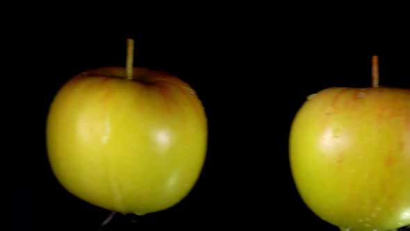 Two Wet Green Apples Collide with Each Other and Scatter in Different Directions