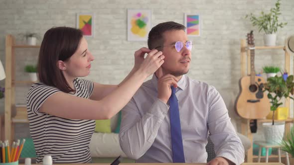 Young Woman Put the Hearing Aid in the Ear Joyful Man