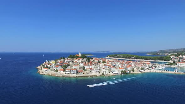 Aerial view of motorboat passing in front of Primosten, Croatia