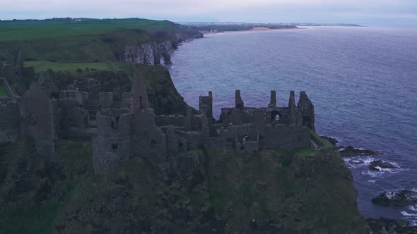 Dunluce Castle on the Antrim Coast, Northern Ireland. Aerial drone pull away