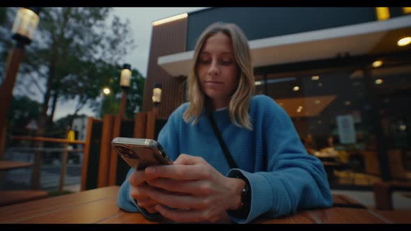 Young Pretty Woman Using Smartphone Outside