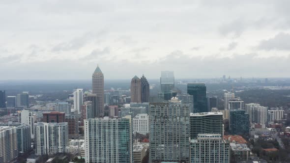 Drone shot above Midtown Atlanta on a cloudy day after a storm. Rising shot facing north into Midtow