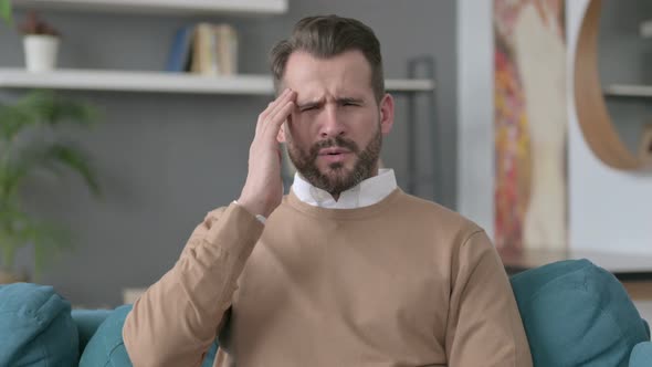 Portrait of Man Having Headache at Home