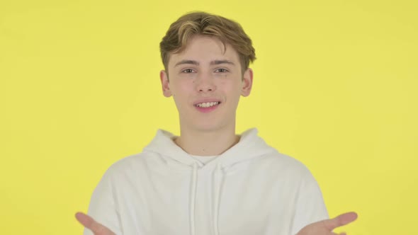 Young Man Talking on Online Video Chat on Yellow Background