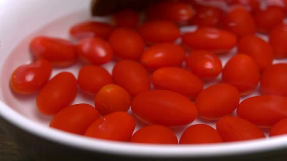 Wooden spoon scoop up cherry tomatoes, Slow Motion
