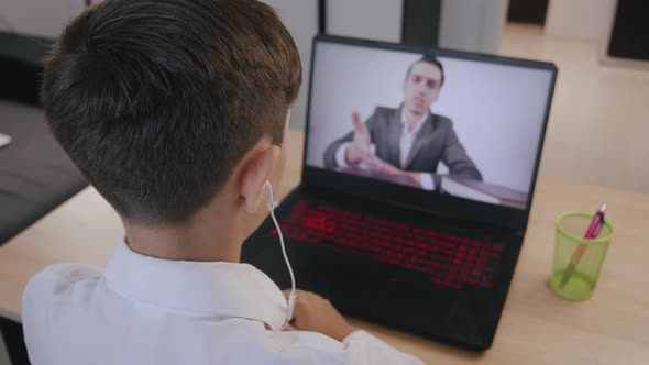 Portrait of Handsome Boy of 12 Ages Using Smartphone at Home. Caucasian Schoolboy Uses a Smartphone