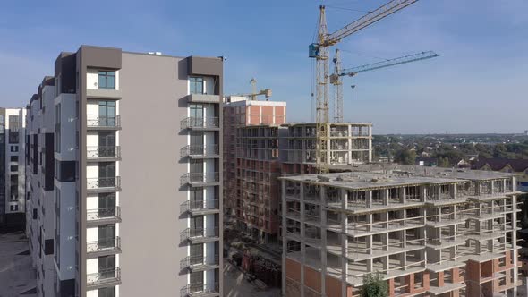 Building crane and monolituc building under construction. Construction site