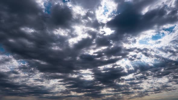 Dramatic Cumulus Cirrus Clouds Move in the Blue Sky. Sunbeams Shine. Time Lapse