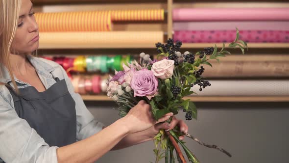 Side View of Professional Female Floral Artist Arranging Beautiful Bouquet at Flower Shop