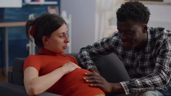 Close Up of Interracial Couple with Pregnancy at Home