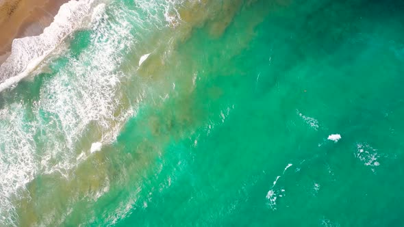 Aerial View of the Mediterranean Coast Waves Reach the Deserted Sandy Beach