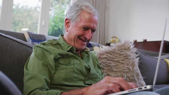 Senior Caucasian man smiling and spending time at home