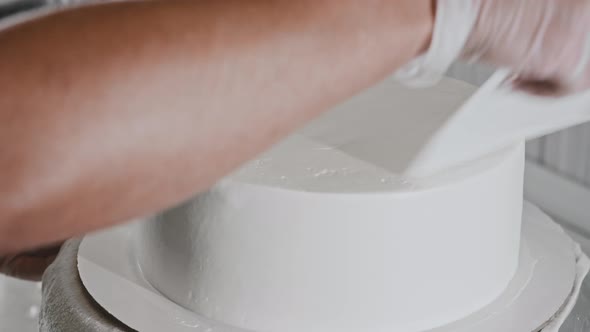 Woman Chef Making a Cake  Smoothes the White Cream on the Cake