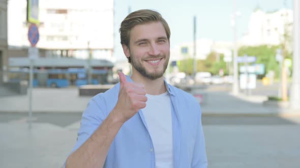 Thumbs Up By Man Standing Outdoor