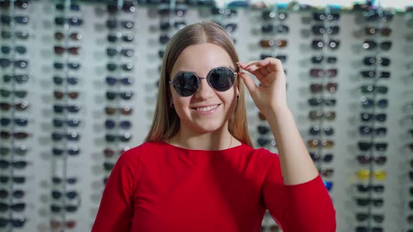 Portrait of a girl in stylish sunglasses indoors. 