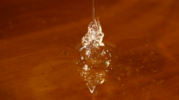 Taking Honey By Using Spoon in Wooden Bowl, Flowing Down, Close Up