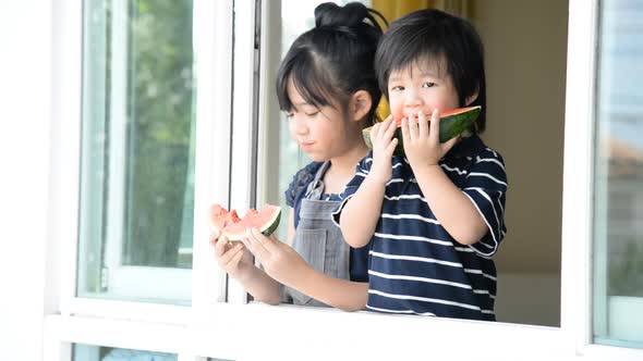 Little Asian Children Eating Watermelon