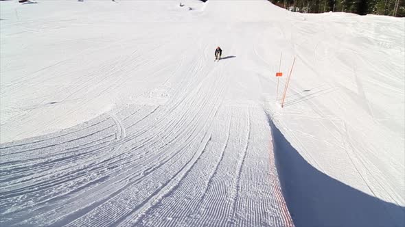 A man skiing down a snow-covered mountain in the winter