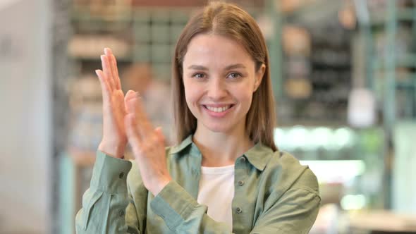 Portrait of Appreciative Young Woman Clapping 