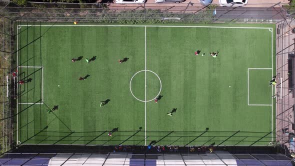 Two Teams of Guys are Playing Football on Field