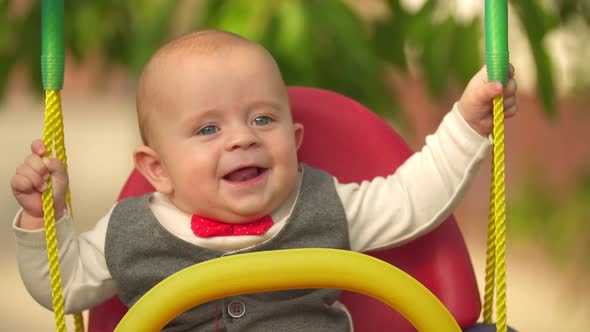 Little Kid Riding a Swing