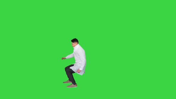 Young Doctor Wearing Lab Coat Does Front Flip Victory! on a Green Screen, Chroma Key