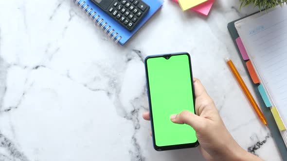 Top View of Women Hand Using Smart Phone with Stationary on Table