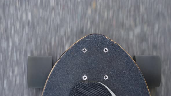 Longboard skating pov on newly laid asphalt road