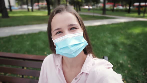 Happy Smiling Girl Communicating Smart Phone During Online Video Chat on Background of Park