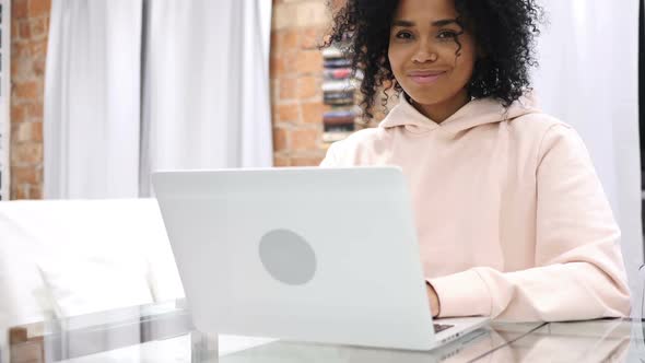 Smiling Positive Young AfroAmerican Woman Model at Work