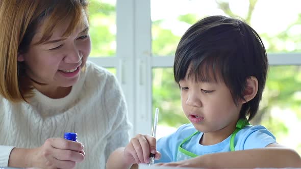 Cute Asian Child And Mother Painting Together