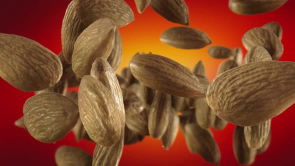 Flying of Almonds in Red Background