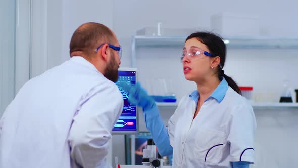 Stressed Scientists Coworkers Discussing About Virus Evolution alt