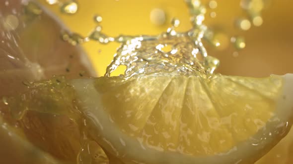 Slow Motion Shot of Lemon Juice Splashing Through Lemon Slices