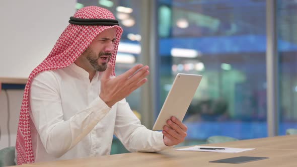 Disappointed Arab Businessman Having Loss on Tablet