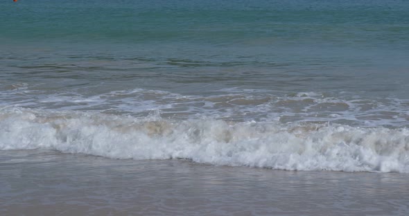 Sandy beach with water wave