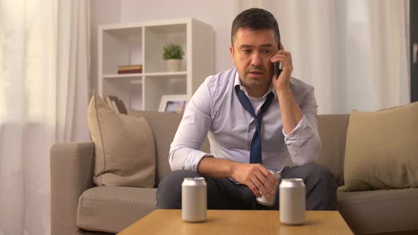 Man Drinking Alcohol and Calling on Smartphone 
