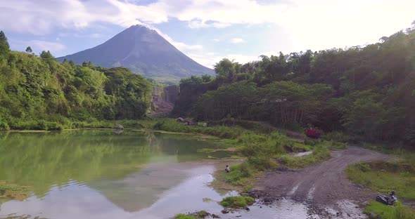 Aerial view of natural lake and driving old truck on pebbly road in bego pendem,Indonesia - Beautifu