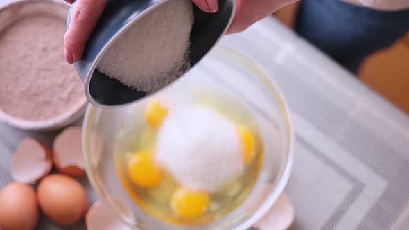 Dough Preparation  Woman Cook Pours Sugar to Glass Bowl with Crushed Eggs