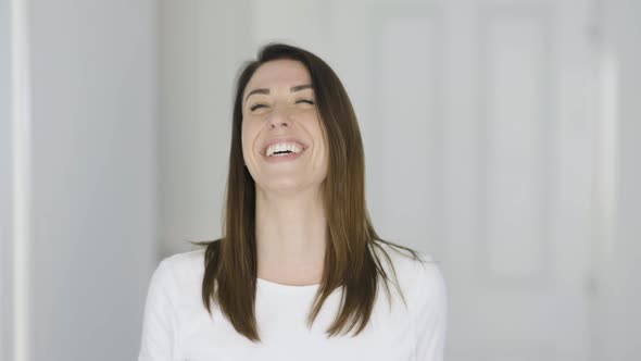 Happy woman laughing at camera