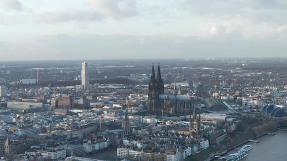 AERIAL: Wide Shot of Cologne Germany From the Air with Majestic Cathedral on Sunny Day 