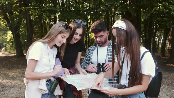 Group of Tourists Searching for Places on Their Map Outdoors