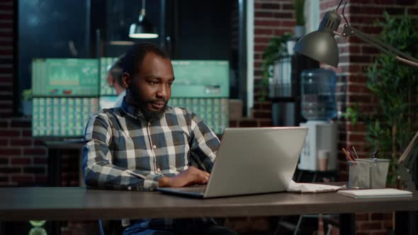 Financial Analyst Working with Stock Market Sales on Laptop