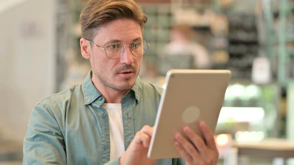 Portrait of Excited Designer Celebrating Success on Tablet