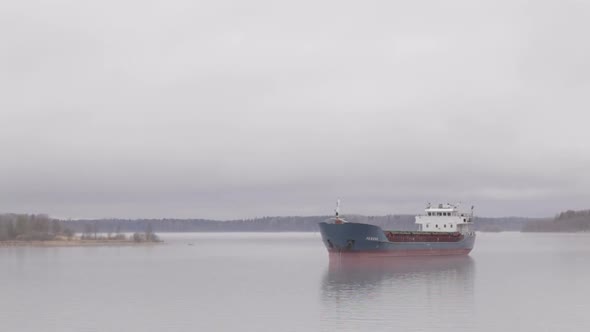 Cargo ship sailing on the Volga river in fog