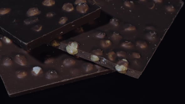 Dark Chocolate Blocks with Nuts Details Slow Close-up Macro. Chocolate Bars
