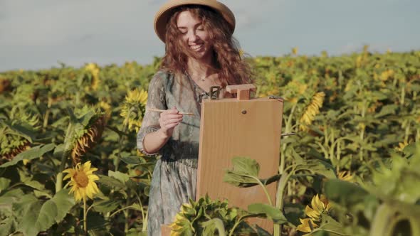 Happy Longhaired Lady Painting with Smile in Colourful Spacious Sunflower Field