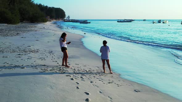 Ladies together happy together on relaxing bay beach lifestyle by blue sea with white sand backgroun