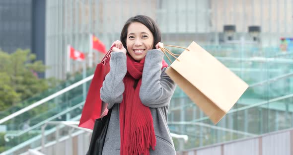 Woman holding shopping bag and use of mobile phone