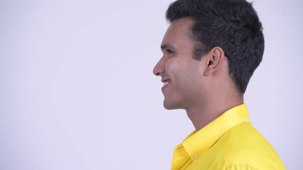 Closeup Profile View of Happy Young Indian Businessman Smiling